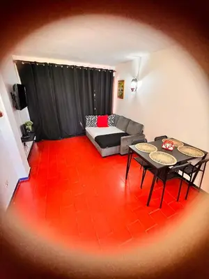 a living room with a couch and a table at Red Apartament Praia da Oura in Albufeira