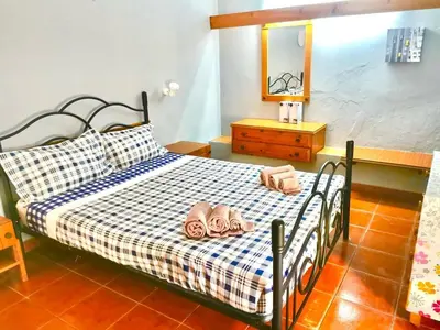 a bedroom with a bed with two flip flops on it at Resort Albufeira T2, Oura Beach in Albufeira