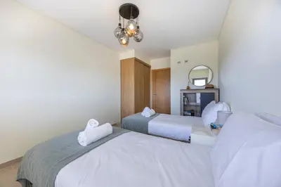 a bedroom with two beds with towels on them at Almargem Apartment in Quarteira