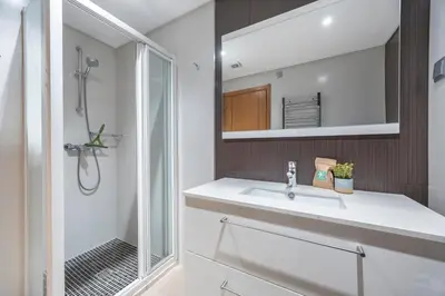 a bathroom with a sink and a shower at Almargem Apartment in Quarteira