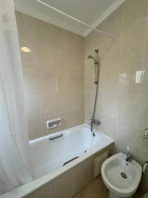 a bathroom with a bath tub and a toilet at Lovely 3 Bedroom Home in a Resort in Albufeira in Albufeira