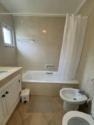 a bathroom with a tub and a toilet and a sink at Lovely 3 Bedroom Home in a Resort in Albufeira in Albufeira