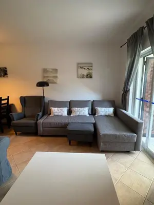 a living room with a couch and a table at Lovely 3 Bedroom Home in a Resort in Albufeira in Albufeira