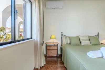 a bedroom with a green bed and a window at #350 Retiro do Abade by Home Holidays in Ferreiras