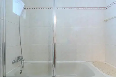 a bathroom with a shower and a white tub at #350 Retiro do Abade by Home Holidays in Ferreiras