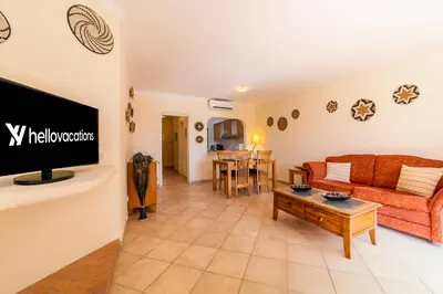 a living room with a couch and a tv at My Inzu by HelloVacations in Albufeira