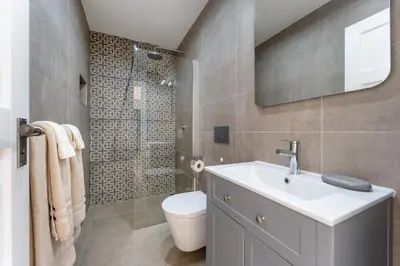 a bathroom with a toilet and a sink and a shower at Villa Benjamin - Vale do Lobo in Vale do Lobo