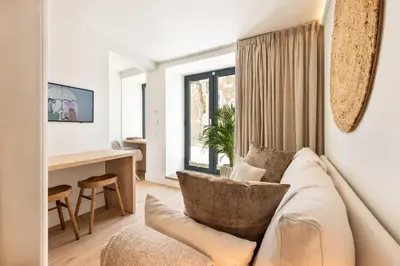 a living room with a couch and a desk at BLQ Charneco 1BDR in Boliqueime by LovelyStay in Boliqueime