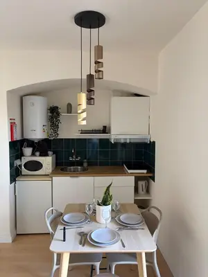 a kitchen with a table with plates on it at Cozy and chic apartment in Albufeira