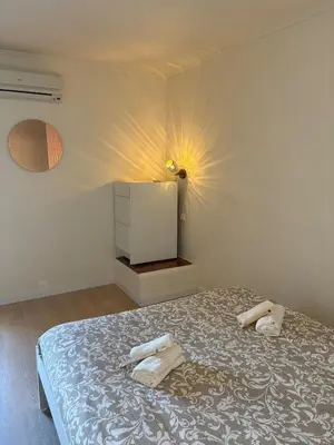 a bedroom with a bed with two towels on it at Cozy and chic apartment in Albufeira