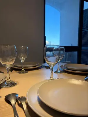 a table with wine glasses and plates on it at Cozy and chic apartment in Albufeira