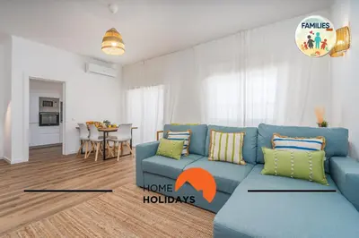 a living room with a blue couch and a table at #281 Families Only -Telecomunicacoes Home Holidays in Albufeira