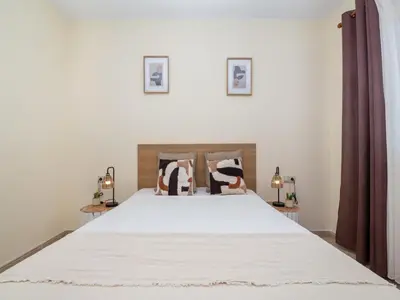 a bedroom with a large white bed with two lamps at Akisol Albufeira Orion in Albufeira
