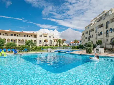 a large swimming pool in front of buildings at Akisol Albufeira Eris in Albufeira