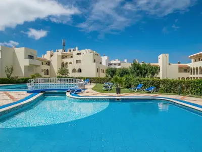a large swimming pool in front of a building at Akisol Albufeira Eris in Albufeira