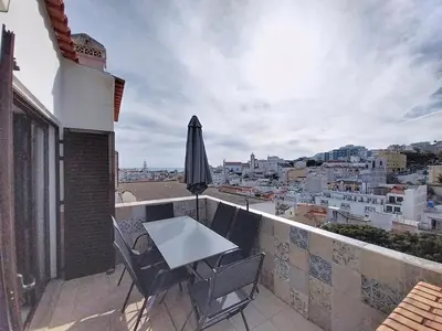 a table and chairs on a balcony with a view at Panorama Old Town sea view Albufeira in Albufeira
