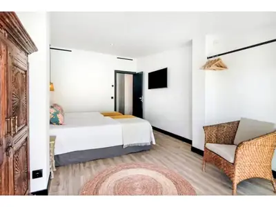 a bedroom with a bed and a chair and a television at Holiday Home Gina - Sunny Way by Interhome in Albufeira