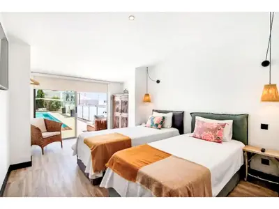 two beds in a hotel room with a pool at Holiday Home Gina - Sunny Way by Interhome in Albufeira