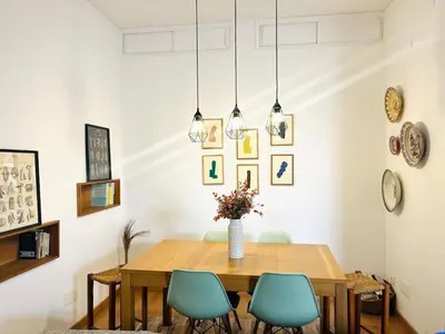 a dining room with a wooden table and blue chairs at Casa Nico in Faro