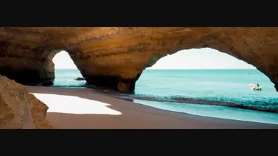 a view of the ocean from a cave on a beach at vista golf in Quarteira