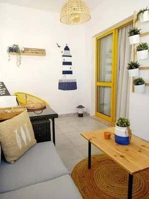 a living room with a couch and a table at Casa de Praia dos Avós in Quarteira