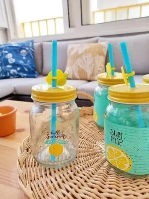 a table with three mason jars on a table at Casa de Praia dos Avós in Quarteira
