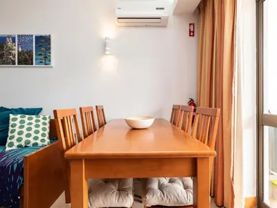 a dining room table and chairs with a bowl on it at Akisol Vilamoura Iron in Quarteira