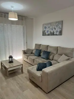 a living room with a couch and a coffee table at Quarteira Atlantic View in Sesmarias