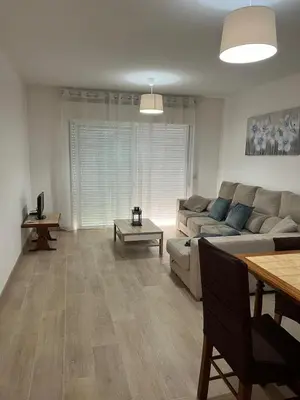 a living room with a couch and a table at Quarteira Atlantic View in Sesmarias