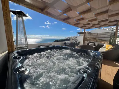 a jacuzzi tub on the balcony of a house at casa do cesar in Albufeira