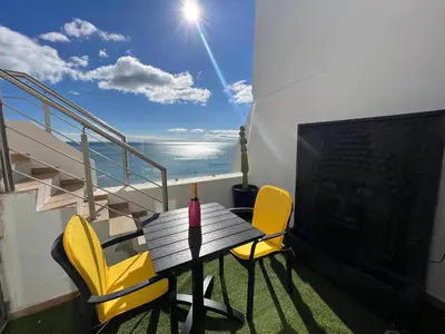 a balcony with a table and chairs on a ship at casa do cesar in Albufeira