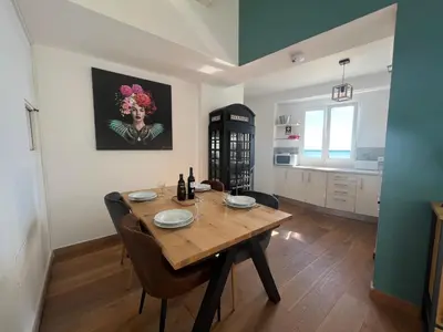 a kitchen and dining room with a wooden table at casa do cesar in Albufeira