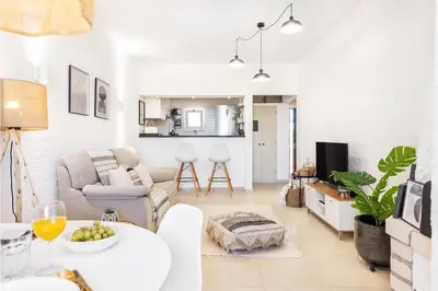 a living room with a couch and a table at Manelinha Apartment - cozy apartment with pool and beach in Quarteira