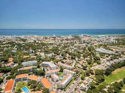 an aerial view of a city with the ocean at Manelinha Apartment - cozy apartment with pool and beach in Quarteira