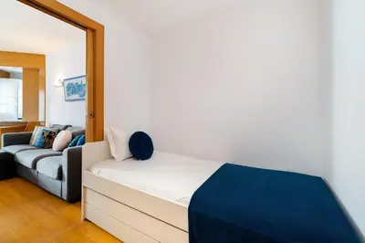 a living room with a bed and a couch at Marina Family Apartment - Pool & Garage in Vilamoura