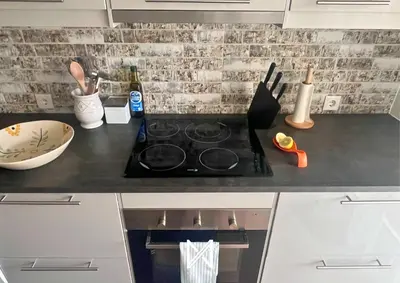 a kitchen counter top with a stove top oven at MyStay - Farol Moura in Quarteira