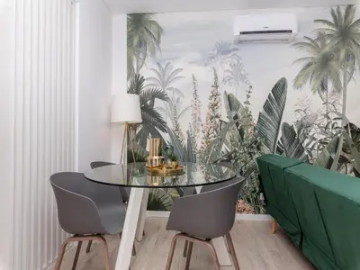 a dining room with a glass table and two chairs at Akisol Faro Virtuous in Faro