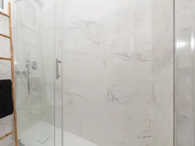 a shower with a glass door in a bathroom at Akisol Faro Virtuous in Faro