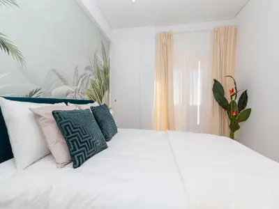 a white bed with pillows on it in a bedroom at Akisol Faro Virtuous in Faro