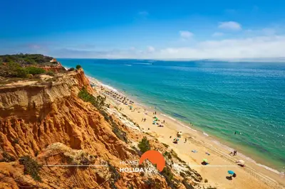 a view of a beach with people on a cliff at #313 Travessa dos Arcos Flat by Home Holidays in Albufeira