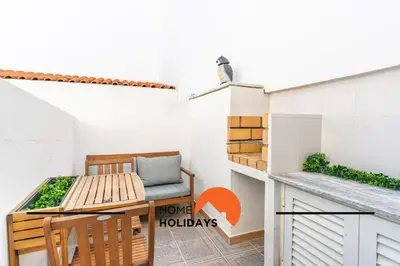 a small balcony with a bench and a house hudleys sign at #313 Travessa dos Arcos Flat by Home Holidays in Albufeira
