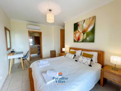 a bedroom with a bed and a desk in it at Two Bedroom Apartment with Sea Views in Albufeira in Albufeira