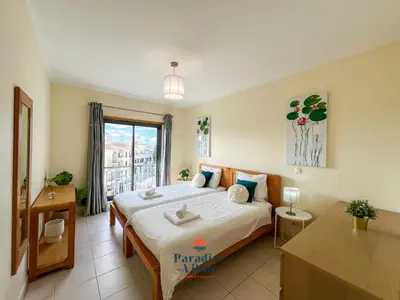 a bedroom with a large bed and a window at Two Bedroom Apartment with Sea Views in Albufeira in Albufeira