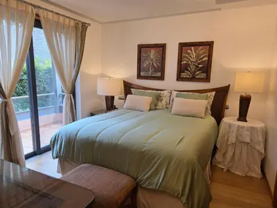 a bedroom with a large bed and a window at Casa dos sonhos em Vale do Lobo in Loulé