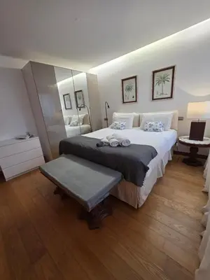 a bedroom with a large bed and a table at Casa dos sonhos em Vale do Lobo in Loulé