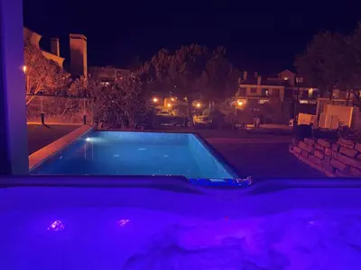 a swimming pool in a backyard at night at Casa dos sonhos em Vale do Lobo in Loulé