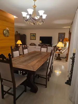 a dining room with a wooden table and chairs at Casa dos sonhos em Vale do Lobo in Loulé