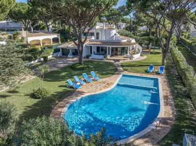 an overhead view of a swimming pool with chairs and a house at Joliet in Vilamoura