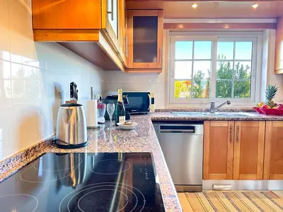 a kitchen with a sink and a counter top at Balaia Poolside House with Sea View by BeCherish in Atalaia