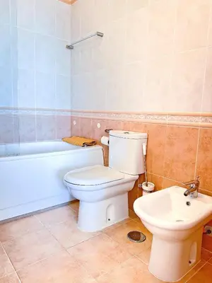 a bathroom with a toilet and a tub and a sink at Balaia Poolside House with Sea View by BeCherish in Atalaia